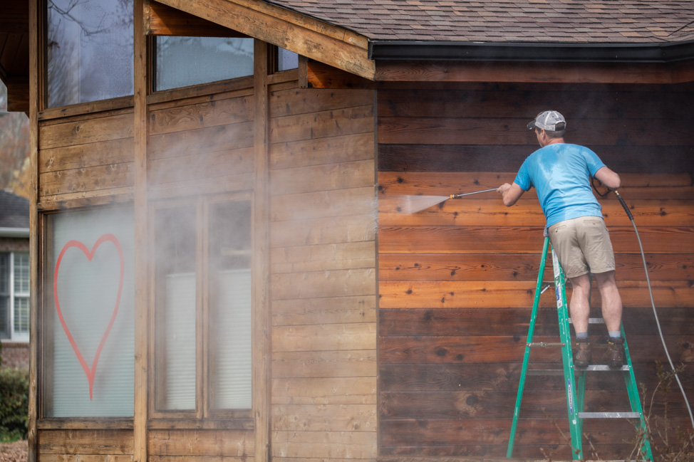 Pressure-washing a cedar house with eco-friendly solution
