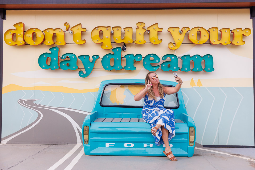 A girl in front of the vintage sign at Far Out Motel in Starkville, Mississippi