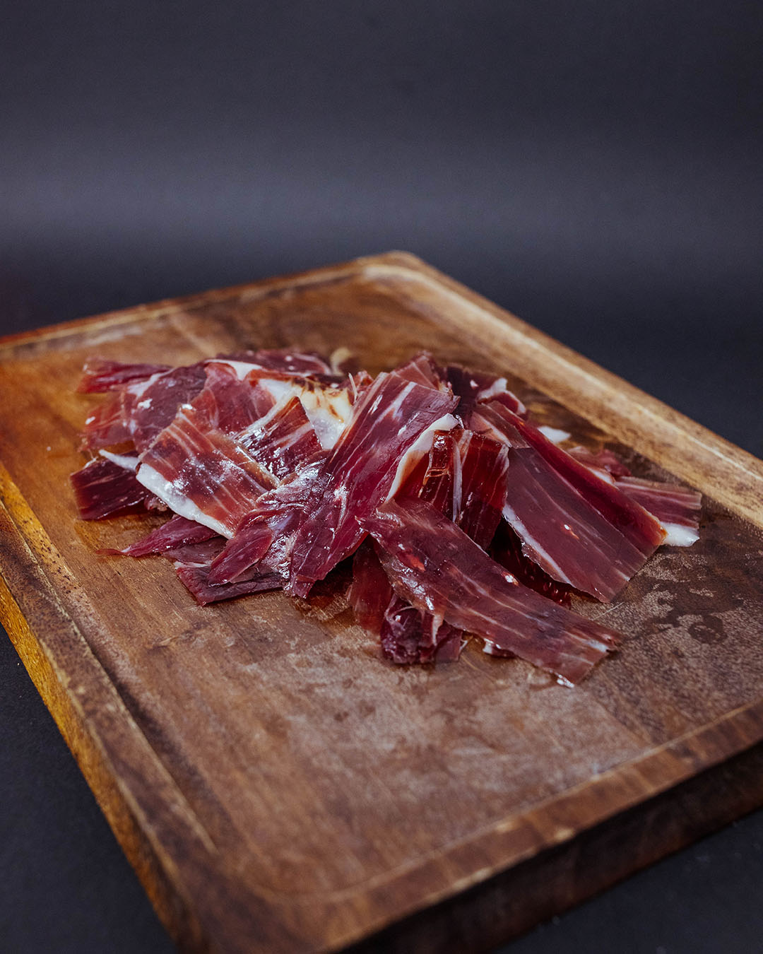 A close-up plate of authentic Spanish Iberian ham (jamón) served in a local Madrid tavern.