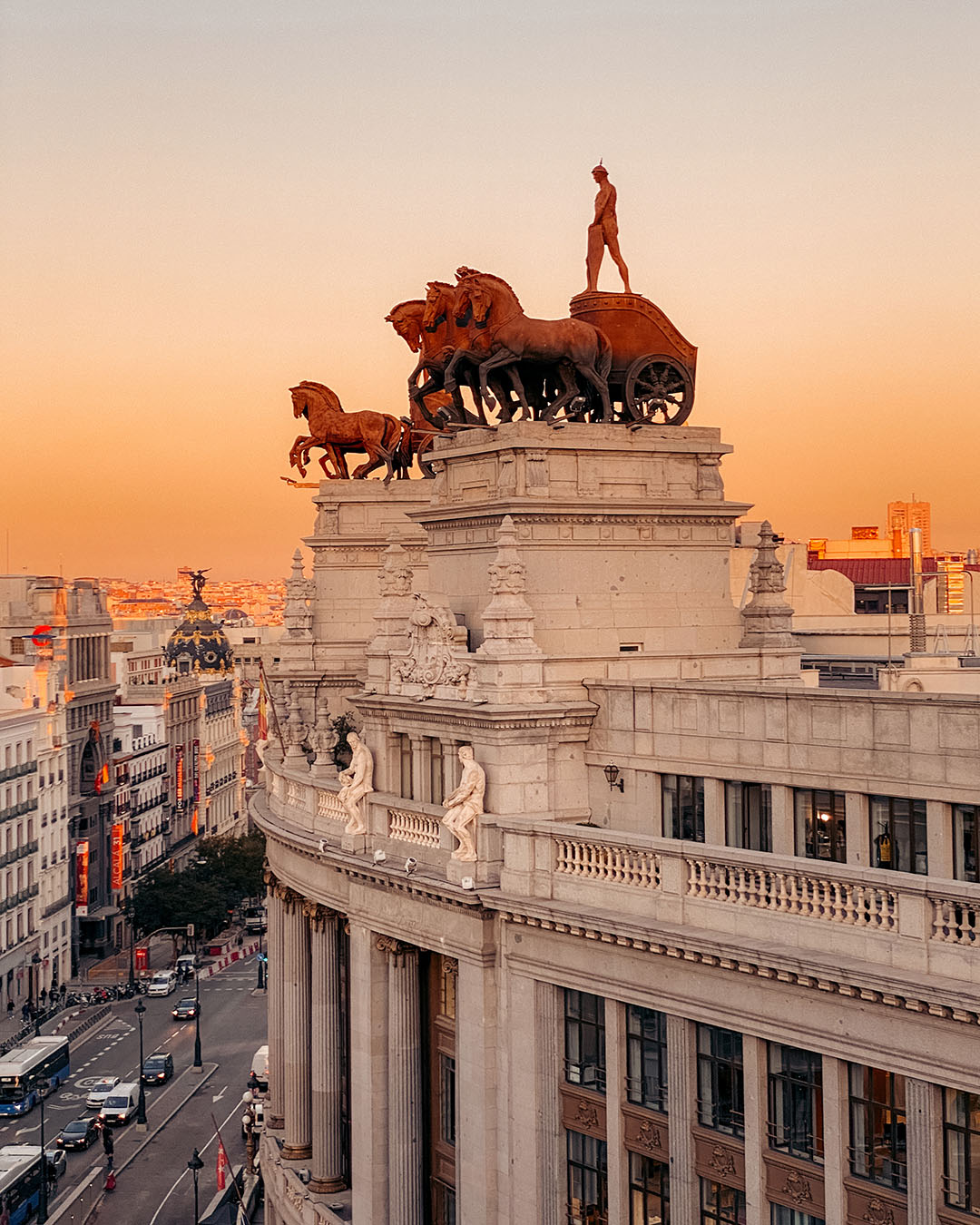 Close-up of the iconic Union and Fenix building on Alcala Street, featuring the famous bronze statue of Ganymede on a Phoenix overlooking Madrid.