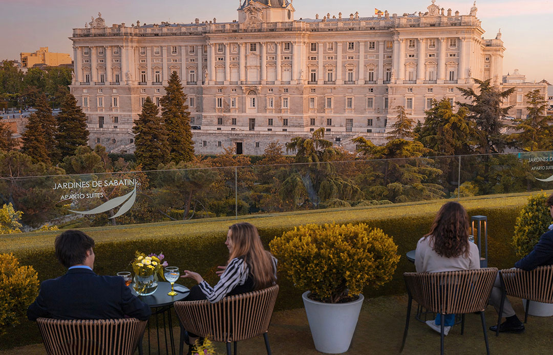 Exterior view of the Royal Palace of Madrid (Palacio Real) under a clear blue sky.