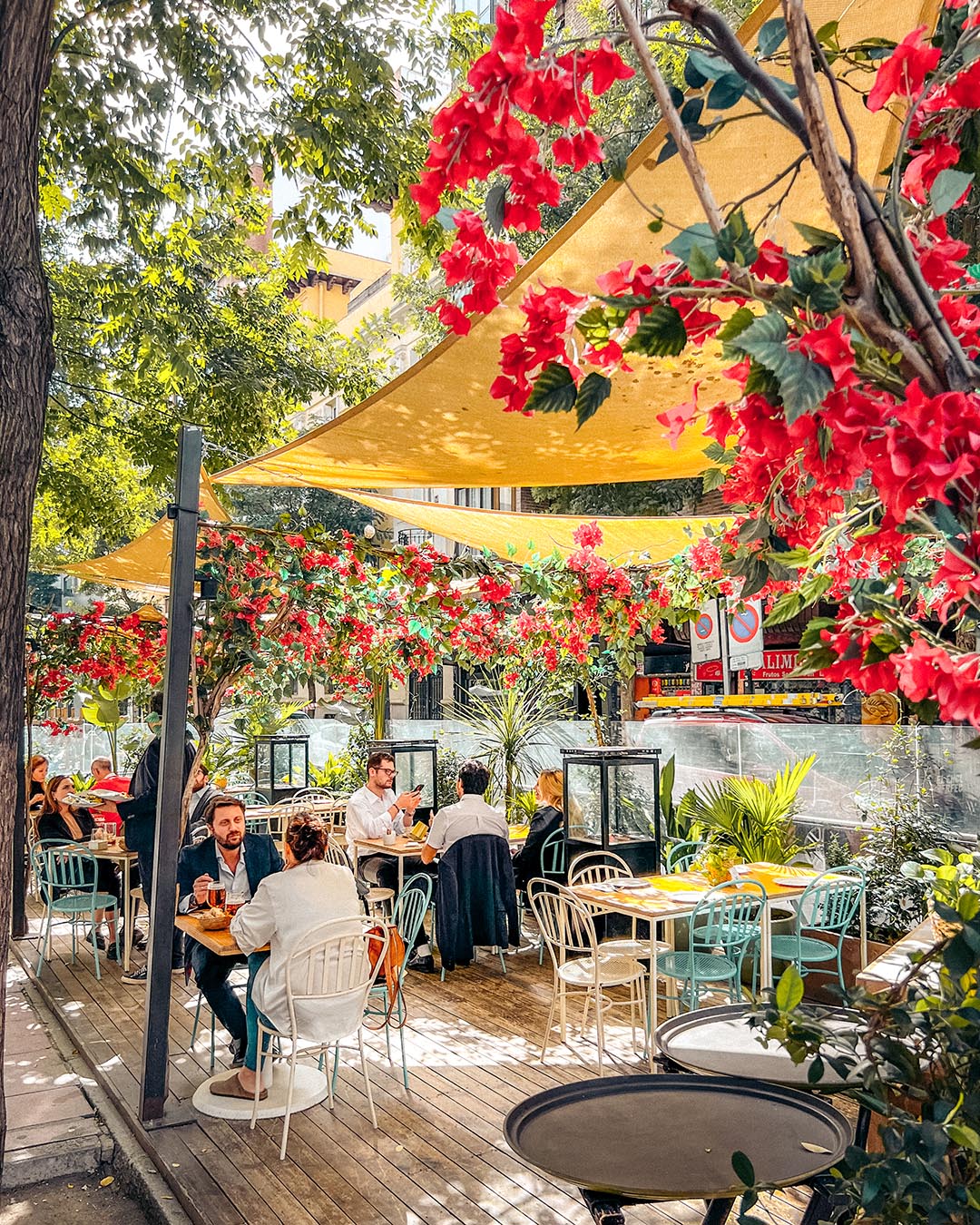 A chic outdoor terrace in the upscale Salamanca neighborhood of Madrid, perfect for the local tardeo afternoon drinks and social lifestyle.