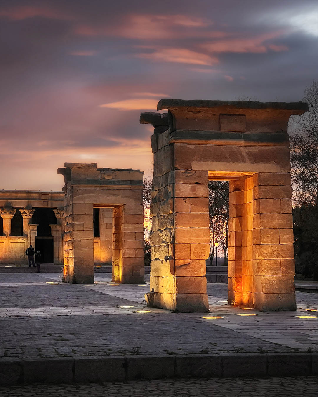 Ancient Egyptian Temple of Debod at sunset with reflections on the water in Madrid.
